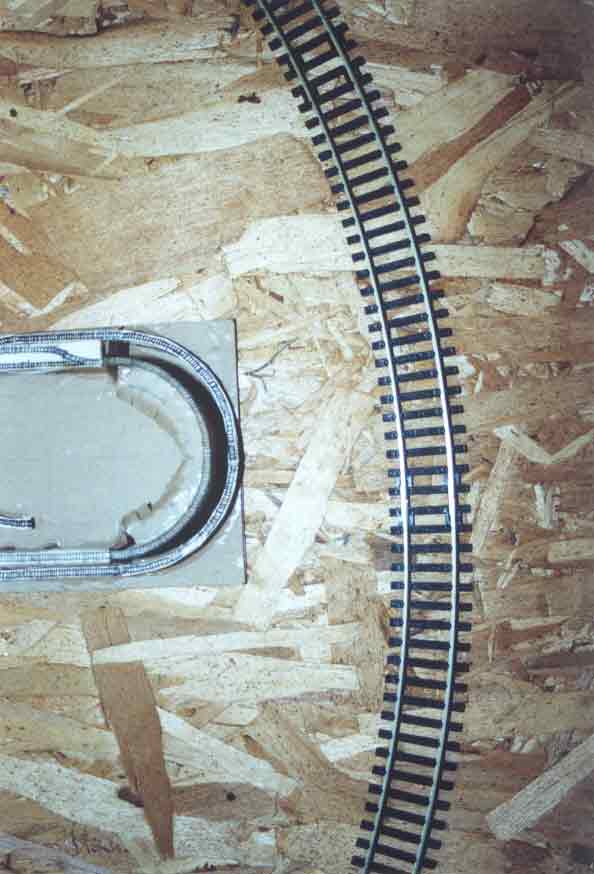 SUBJECT: Hornby track, trial fit on baseboard with 'Concept-2' first version 

CAMERA:  Canon EOS Rebel-X SLR
MEDIA:  Kodak ISO 400 4-inch by 6-inch glossy print
FILE:  JPEG from HP 4100C scanner
EDITING:  Adobe Photoshop