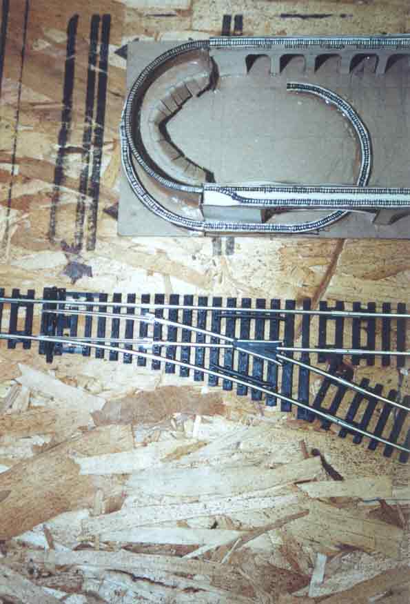 SUBJECT: Hornby track, trial fit on baseboard with 'Concept-2' first version 

CAMERA:  Canon EOS Rebel-X SLR
MEDIA:  Kodak ISO 400 4-inch by 6-inch glossy print
FILE:  JPEG from HP 4100C scanner
EDITING:  Adobe Photoshop